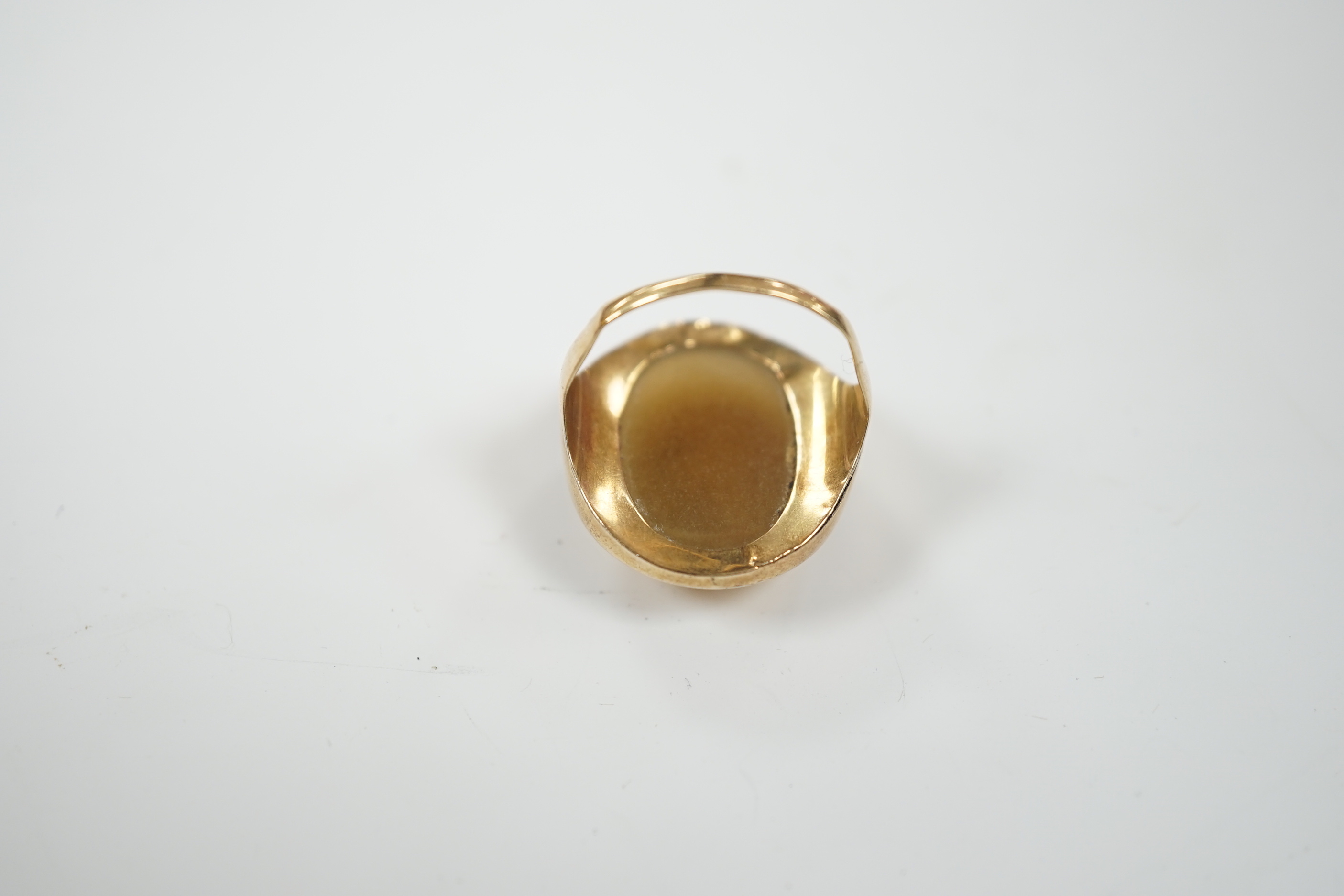 An early 20th century yellow metal and banded agate intaglio ring, carved with the head of a gentleman to sinister, size L, gross weight 8.1 grams.